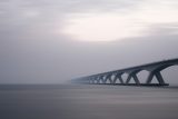 color picture of a bridge shrouded in fog